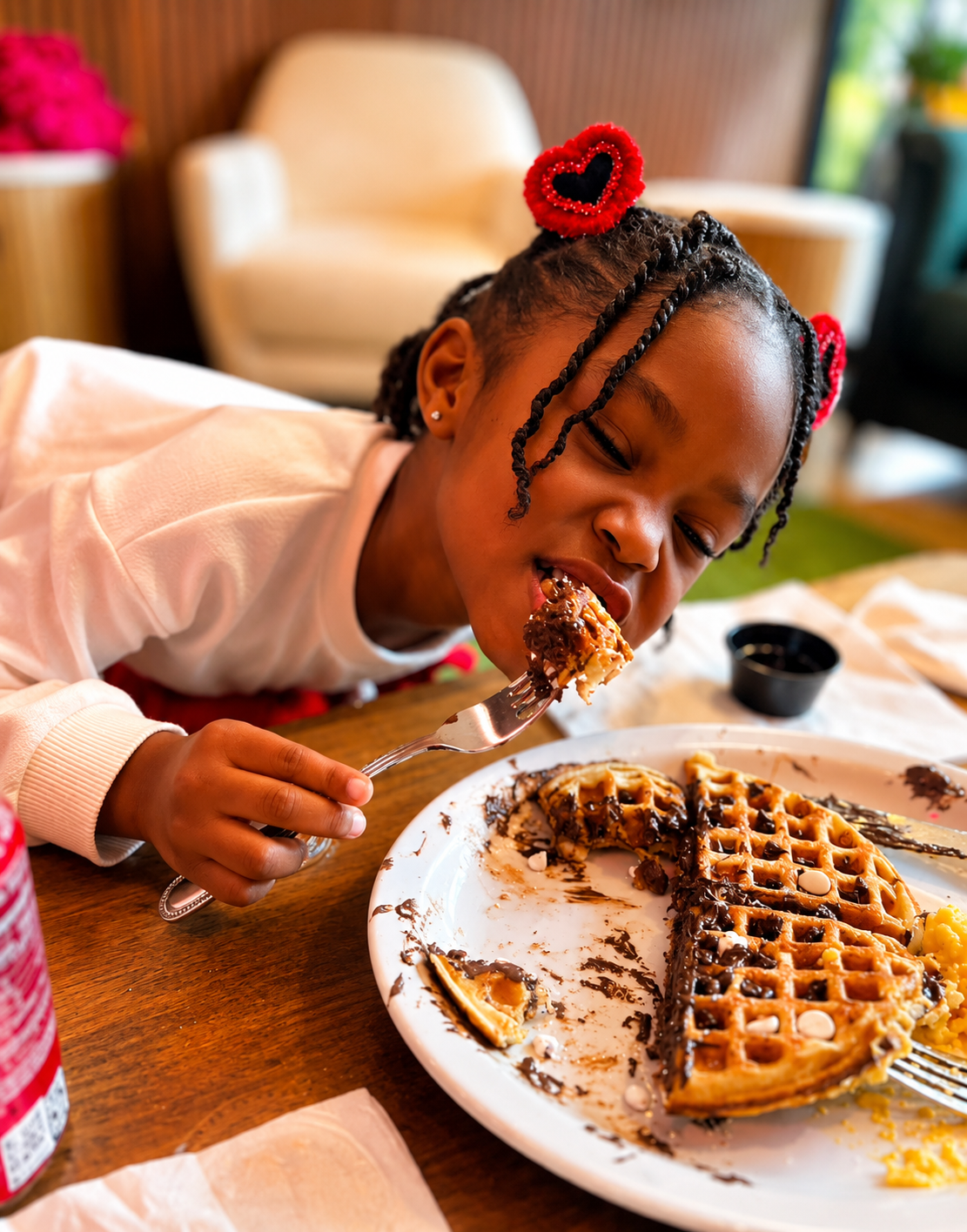 Young guest enjoying chocolate chip waffles at Brick Bistro Sunday brunch